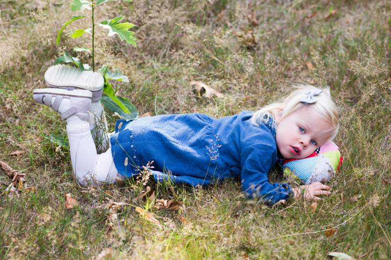 Little girl lying on the grass. 