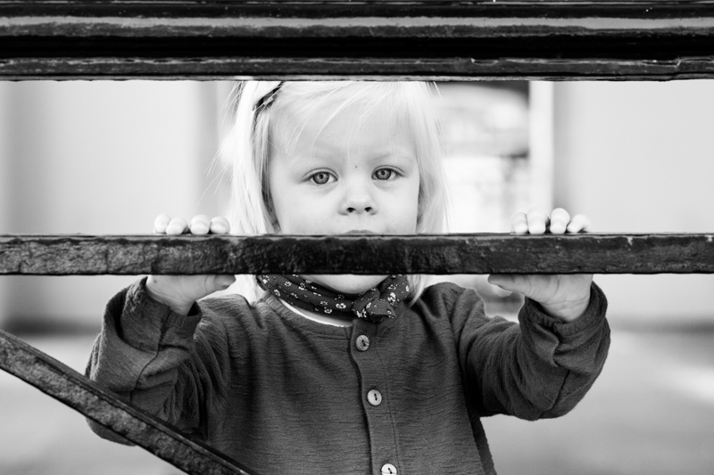Little girl peeping above railing. 