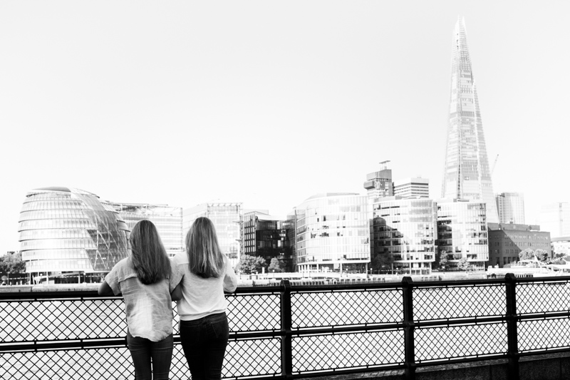Mum and girl looking at view of London across the River Thames. 