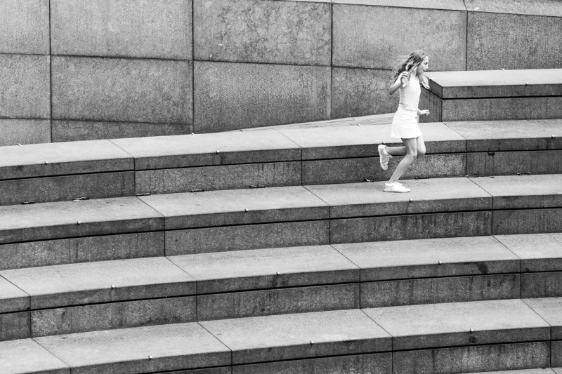 Girl running along steps. 