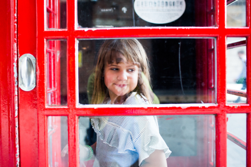 Girl in red phonebox. 