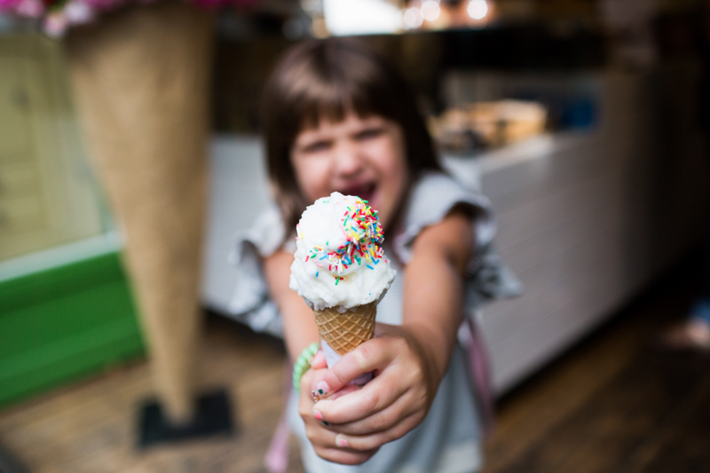 Girl holding out ice-cream. 