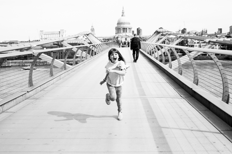 Girl running away from St Paul's Cathedral. 