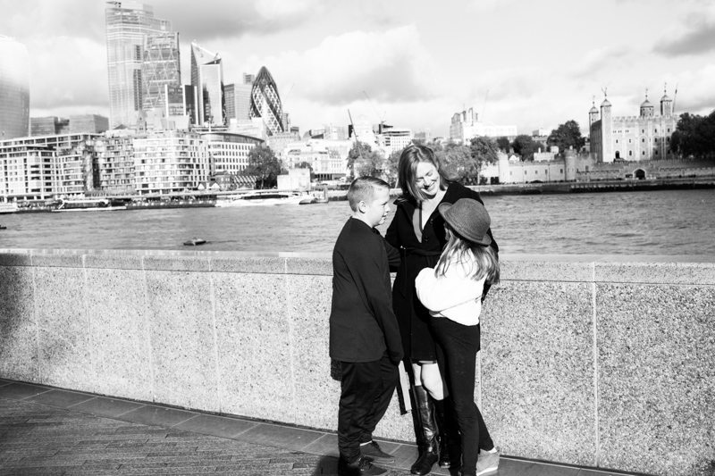 Lady, girl and boy in front of the City of London.