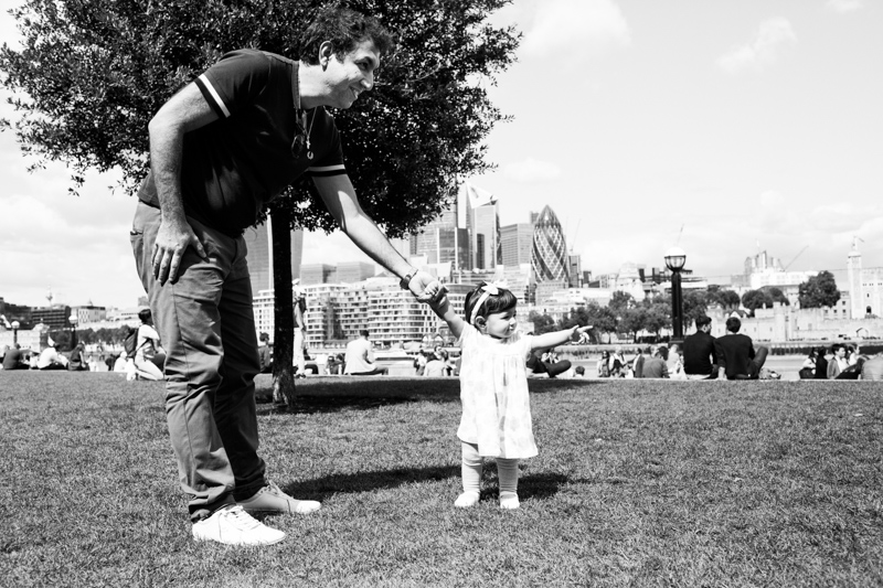Little girl pointing with City of London in the background. 