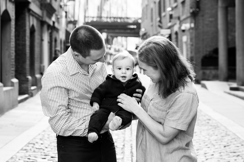 Man and lady holding baby between them.