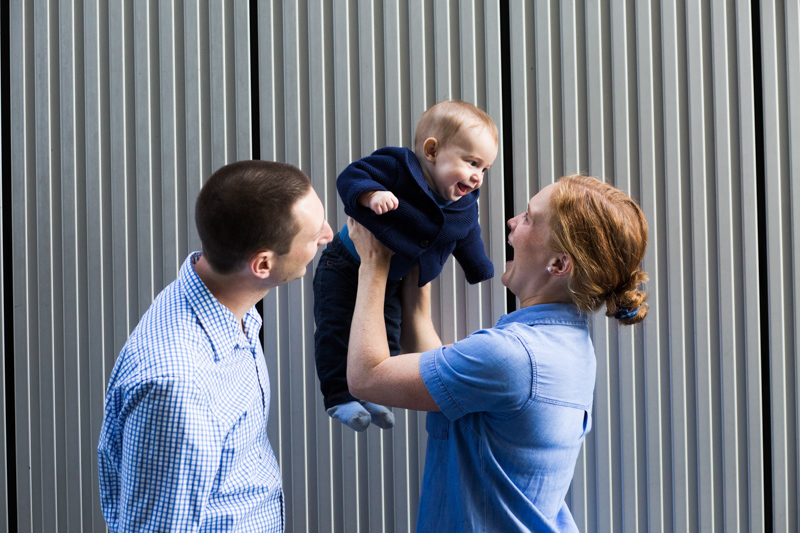 Mum lifting her baby up next to dad.