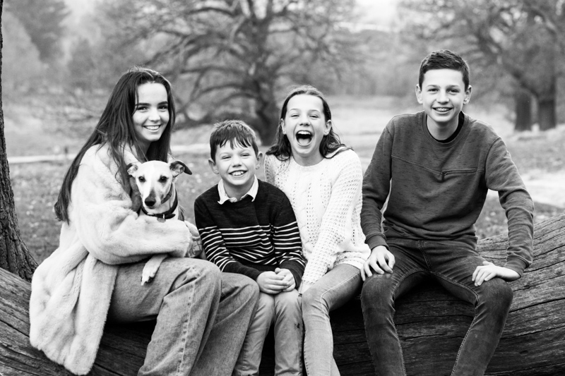Four children and dog smiling