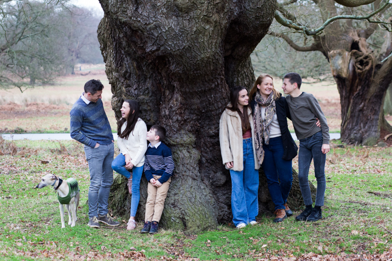 Mum, dad and four children in front of huge tree