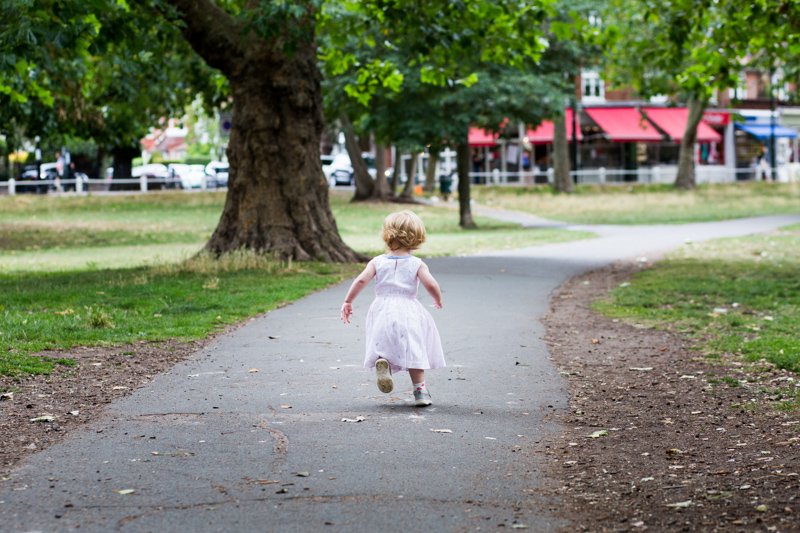 little girl walking away down a path