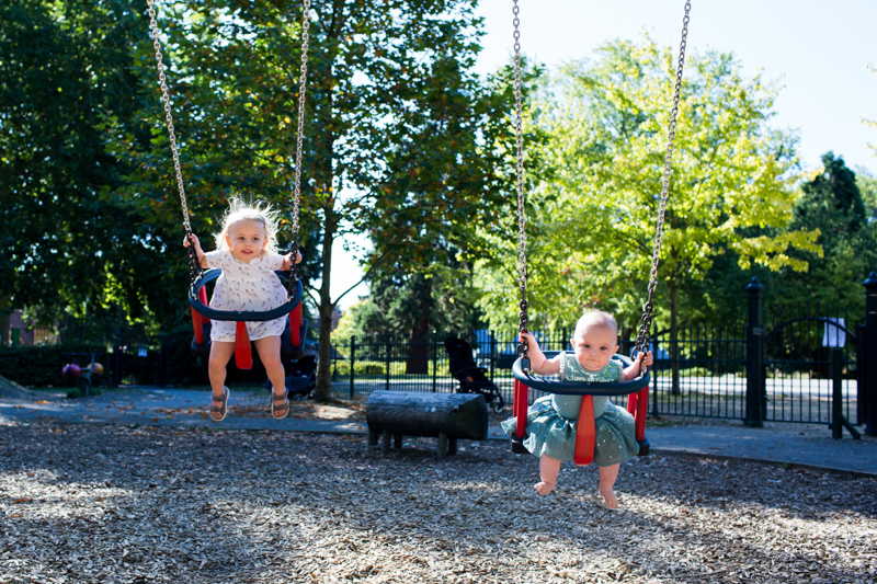 girl and baby on two swings