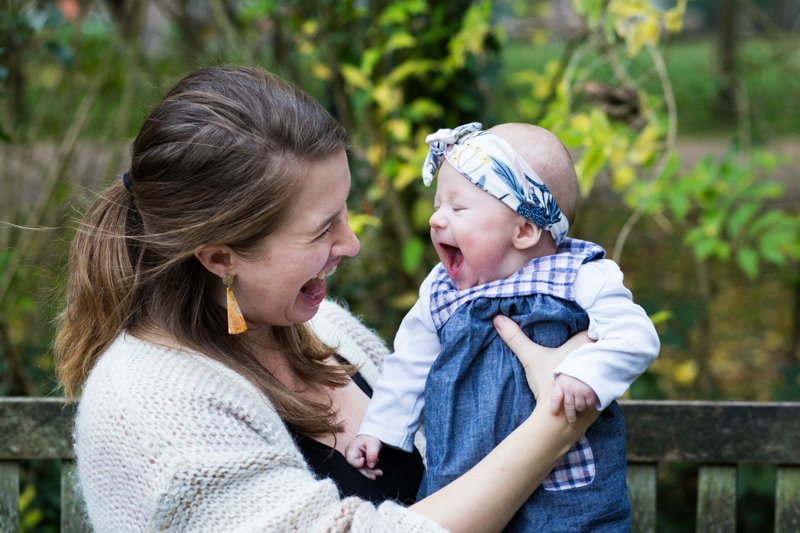 Mum and baby girl laughing together. 