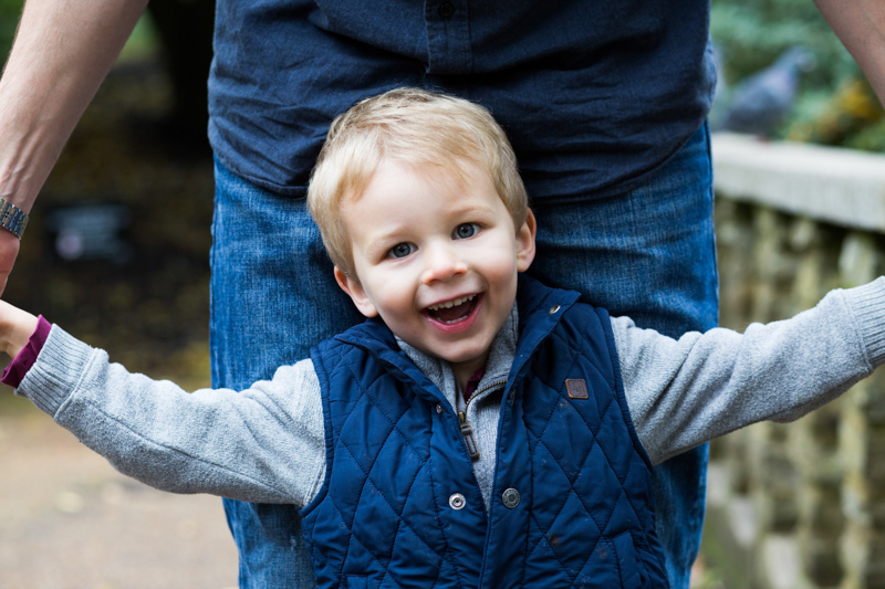 Little boy in blue jacket smiling. 