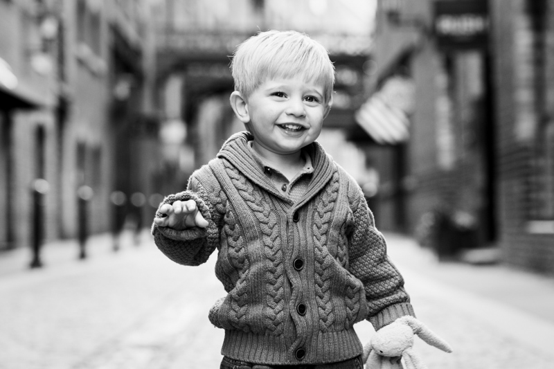 boy smiling in cobbled street