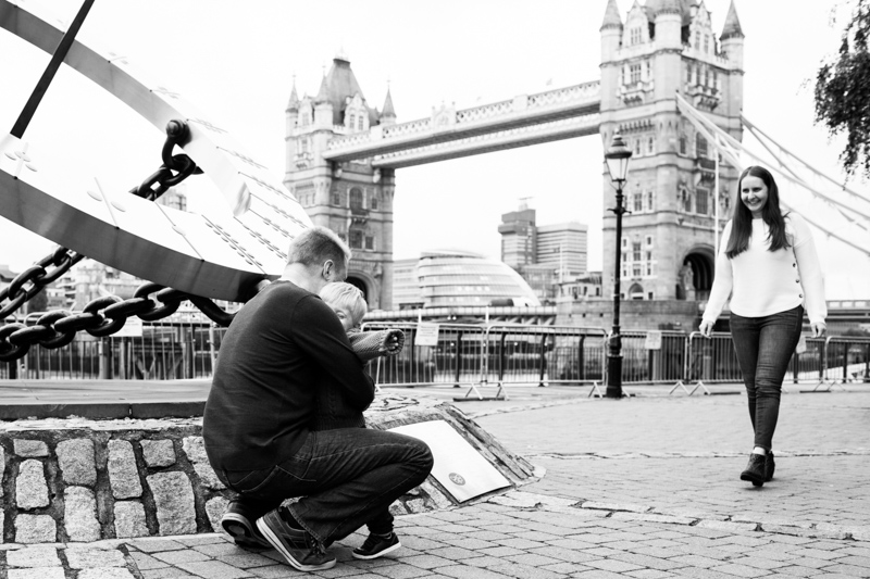 boy hugging dad in front of Tower Bridge