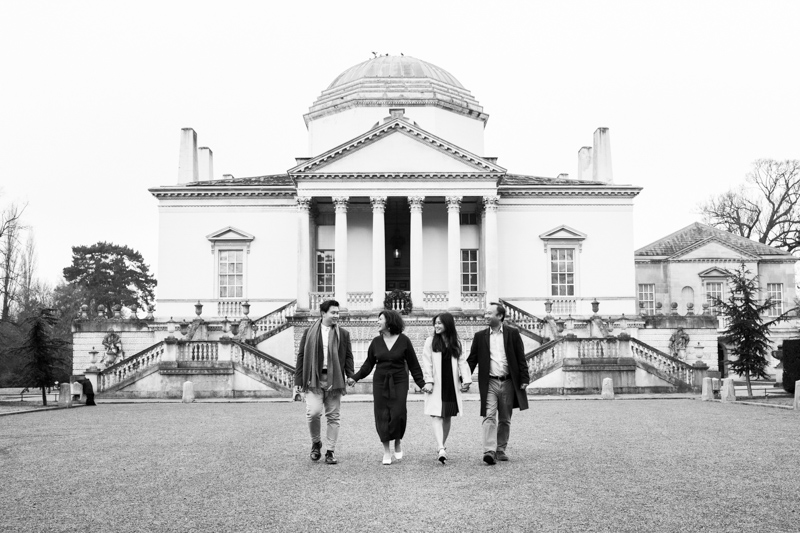 Family of four walking in front of Chiswick House