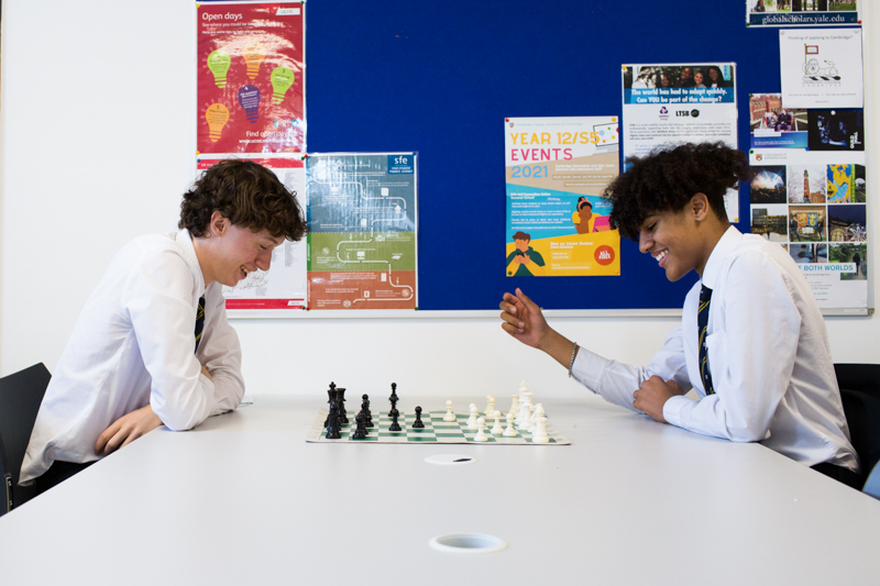 Two schoolboys playing chess. 