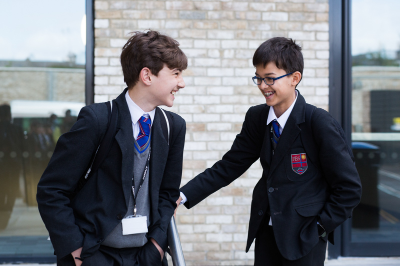 two schoolboys laughing