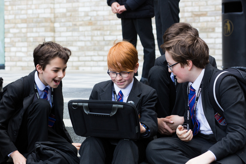 schoolboys looking at a laptop 