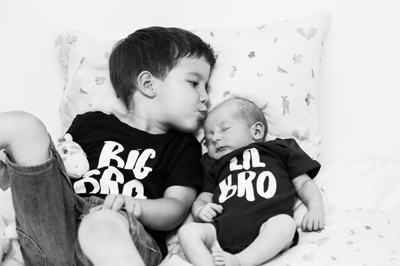 boy kissing his baby brother.