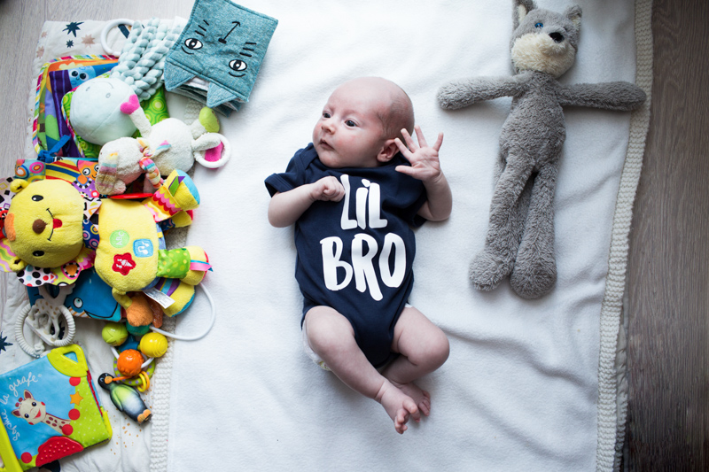 Little baby wearing "Lil Bro" top.