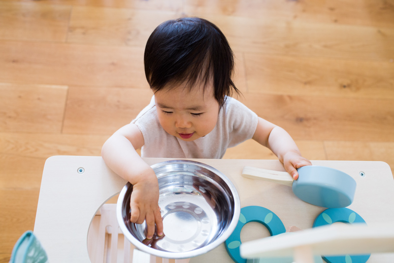 Baby playing with toy sink. 