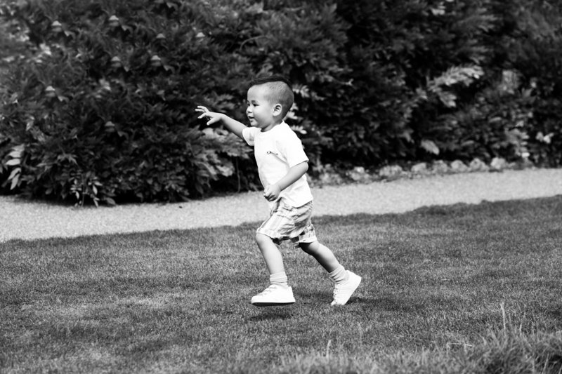 Boy running across the grass. 