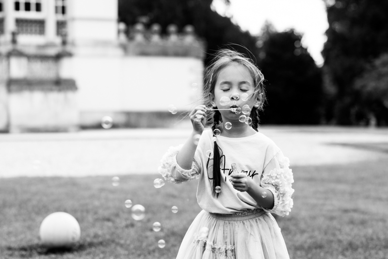 Girl blowing bubbles outdoors. 