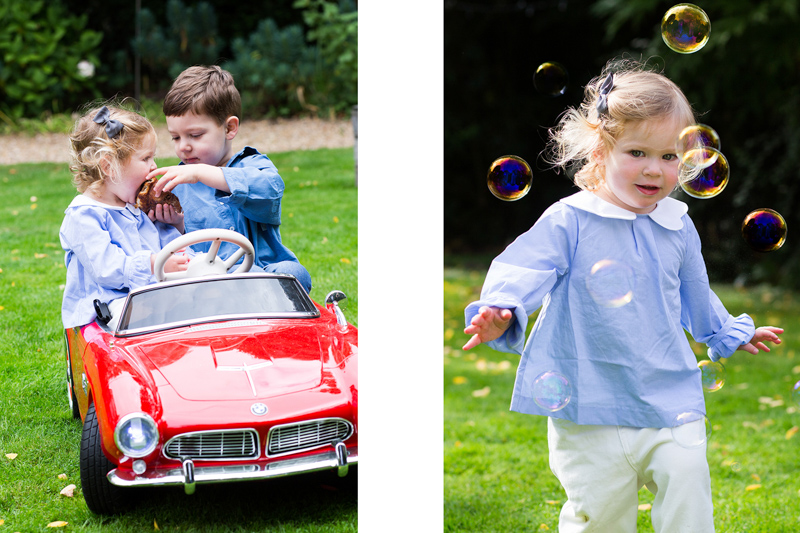 Boy sharing pastry with little girl in red car, and girl running through bubbles. 