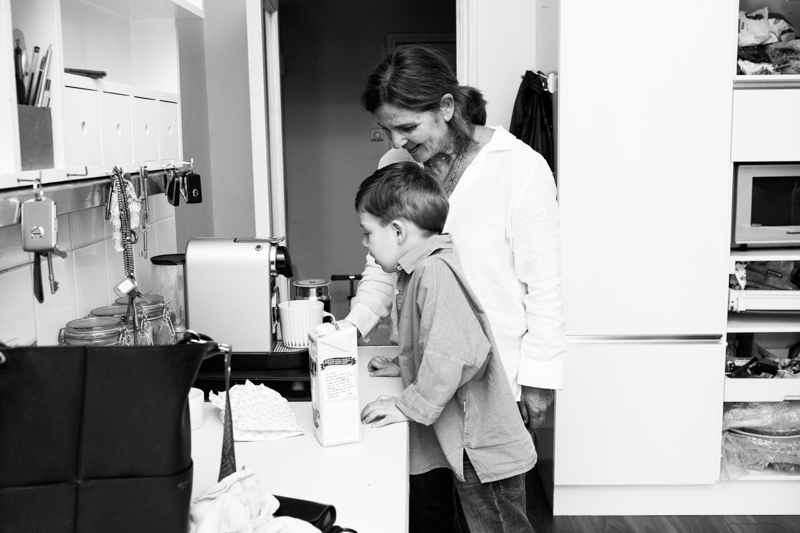 boy and older lady looking at a coffee machine. 
