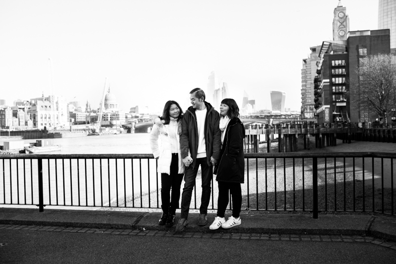 One man and two ladies in front of the Oxo Building. 
