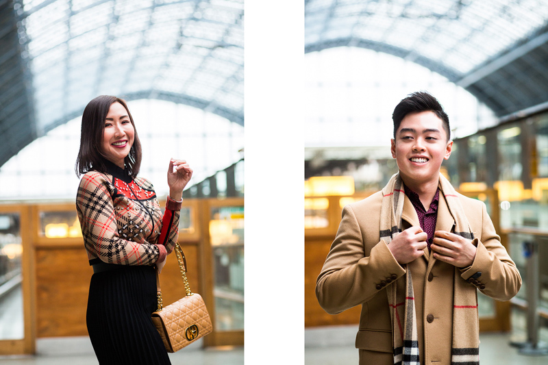 Man and lady smiling in St Pancras Station. 