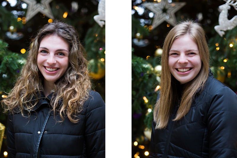 Two young ladies in front of a Christmas tree. 