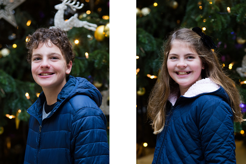 Boy and girl in front of a Christmas tree. 