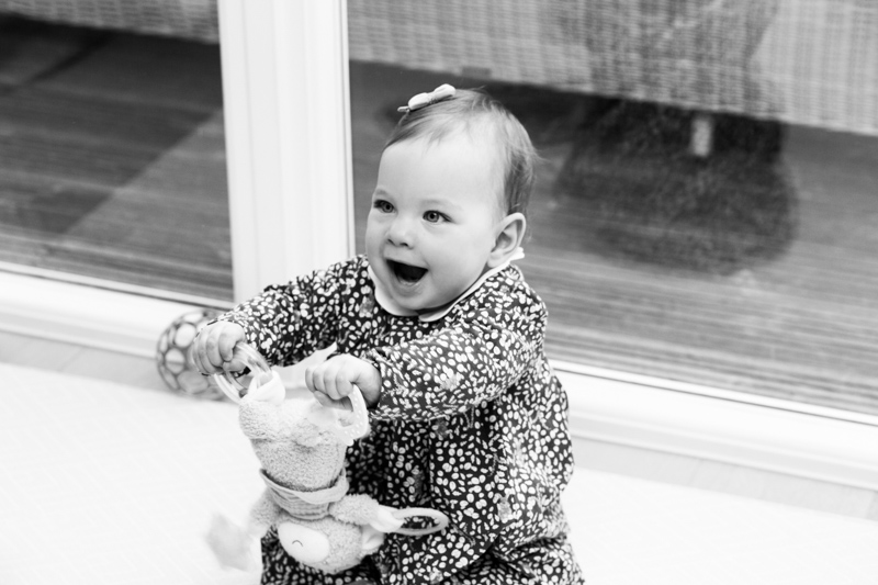 Happy baby girl playing with toy. 