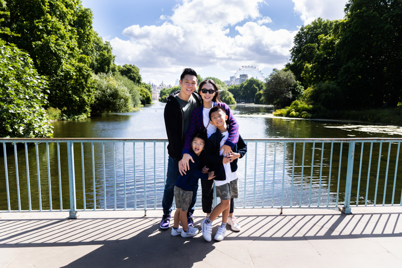family of four in front of lake, with The London Eye in the distance