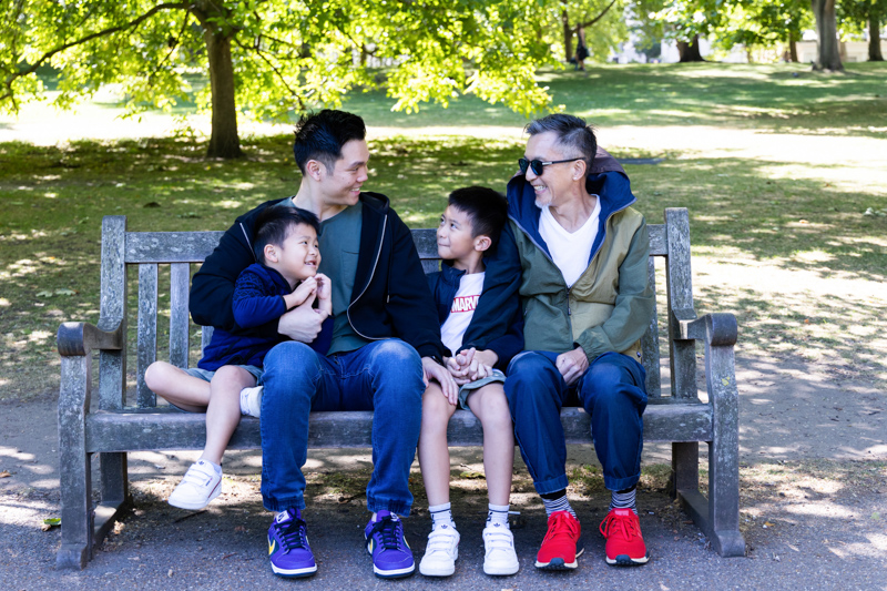 four family members sitting on a bench