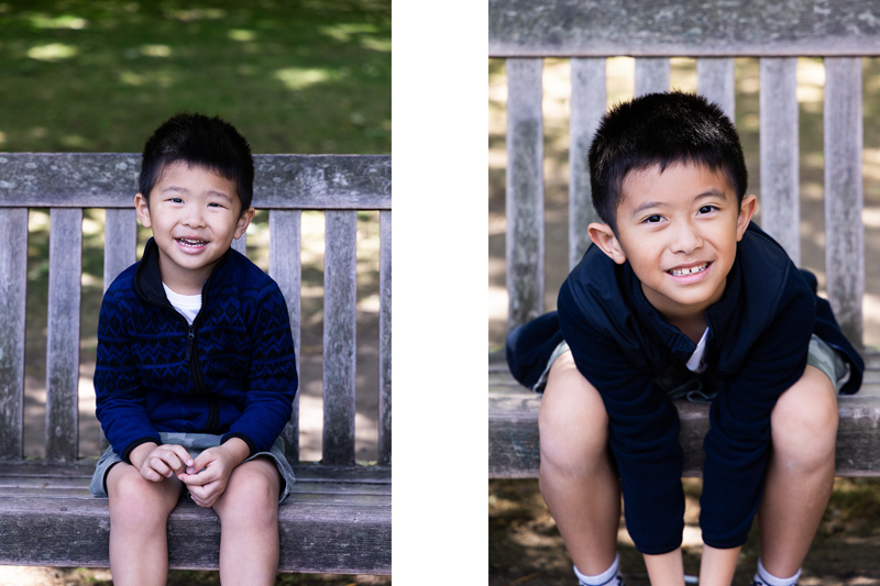 two smiling boys sitting on a bench