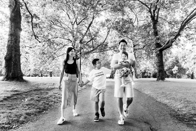 Family of four walking through the park