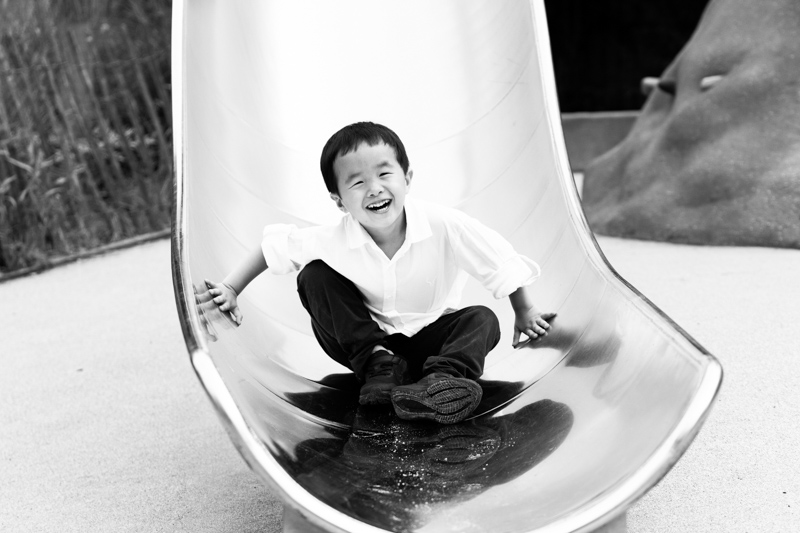 Smiling boy at the bottom of a slide