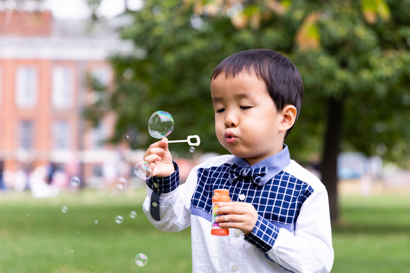 Little boy blowing bubbles