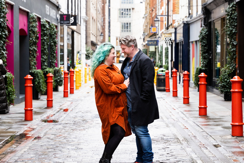 Man and lady looking at each other in colourful street