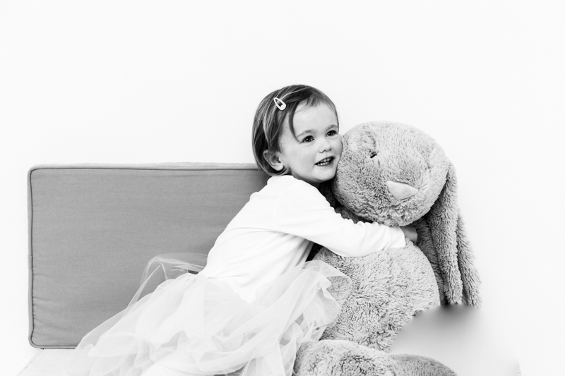 young girl cuddling her large toy rabbit