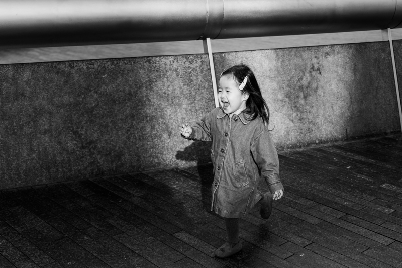 Happy girl running along laughing.