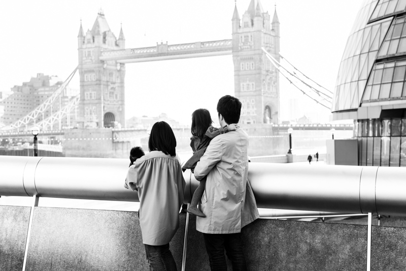 family of four looking out towards Tower Bridge