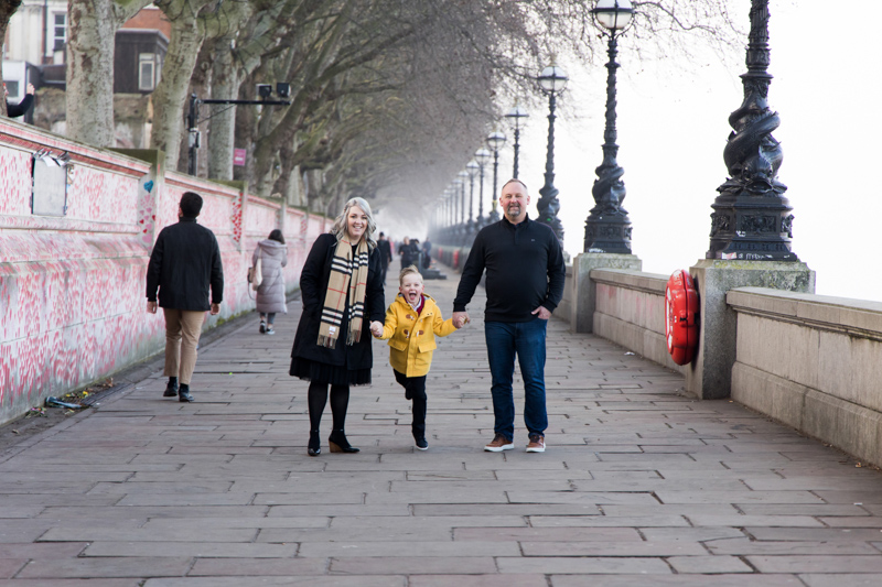 man, lady and happy boy walking