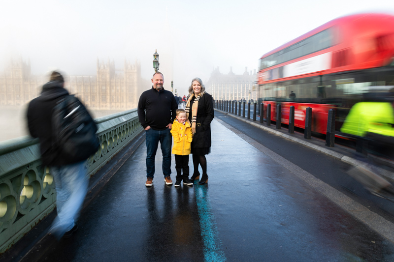 man, lady and boy on Westminster Bridge with Houses of Parliament in the background