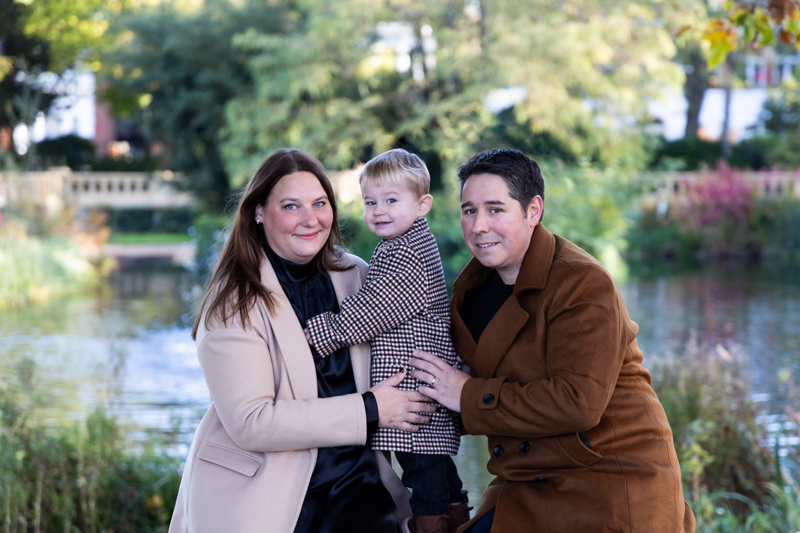 Boy with man and lady with trees behind them.