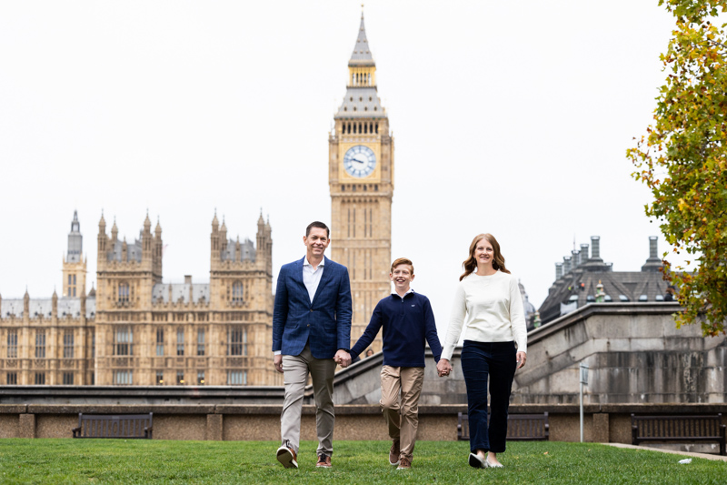 Mum, dad and son walking in front of the Houses of Parliament and Big Ben.