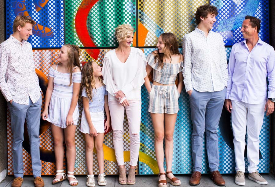 Family lined up against a wall
